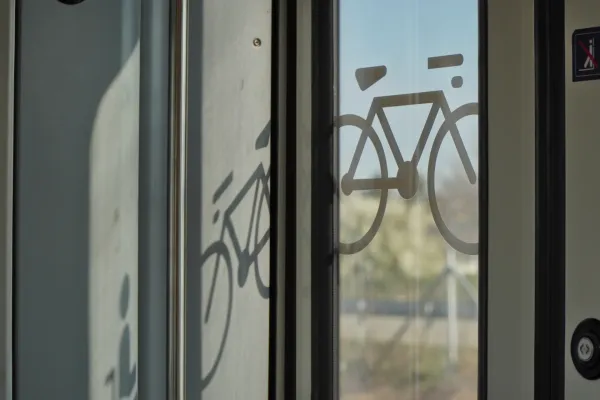 Symbol of a bicycle on the glass door of a train in Belgrade, Serbia, indicating bicycle transport.