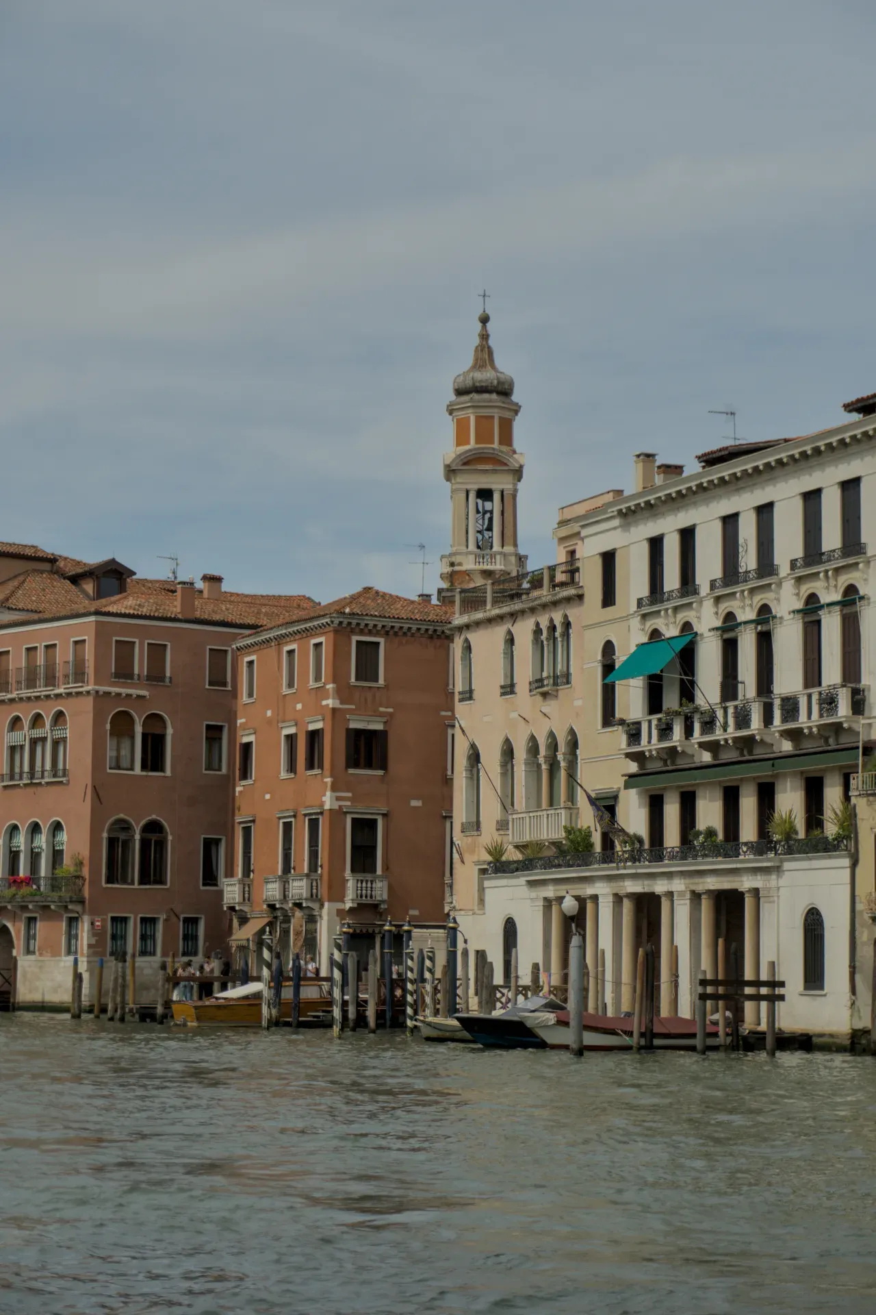 Photograph of buildings on the Grand Canal in Venice, Italy, with a prominent bell tower and boats in the water.
