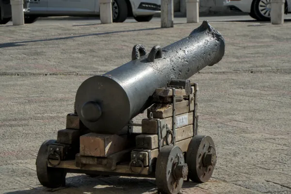 A historic cannon on wheels guards the entrance to the Old Town of Kotor, Montenegro.
