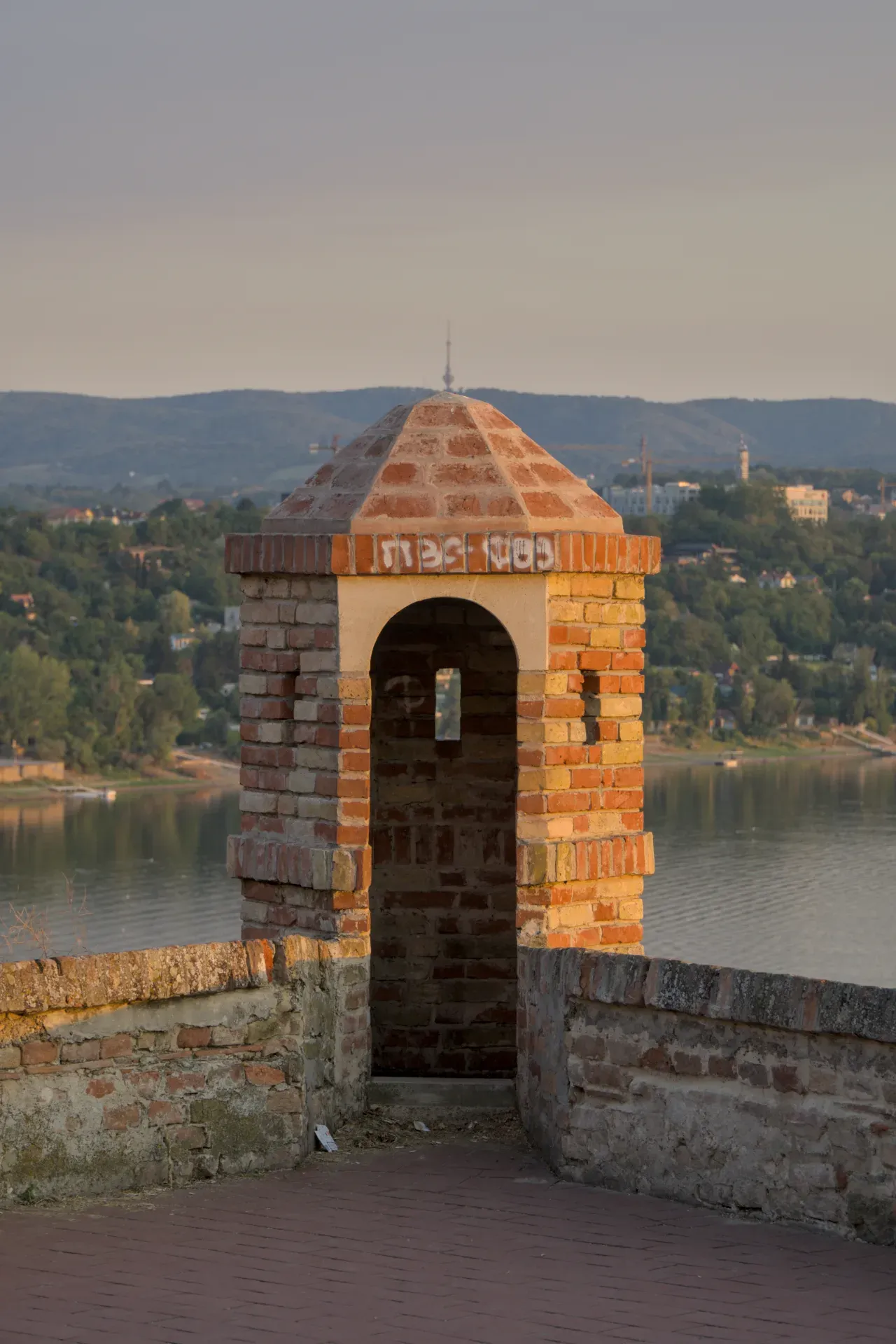 The watchtower of Petrovaradin Fortress with the television tower on Fruška Gora in the background.