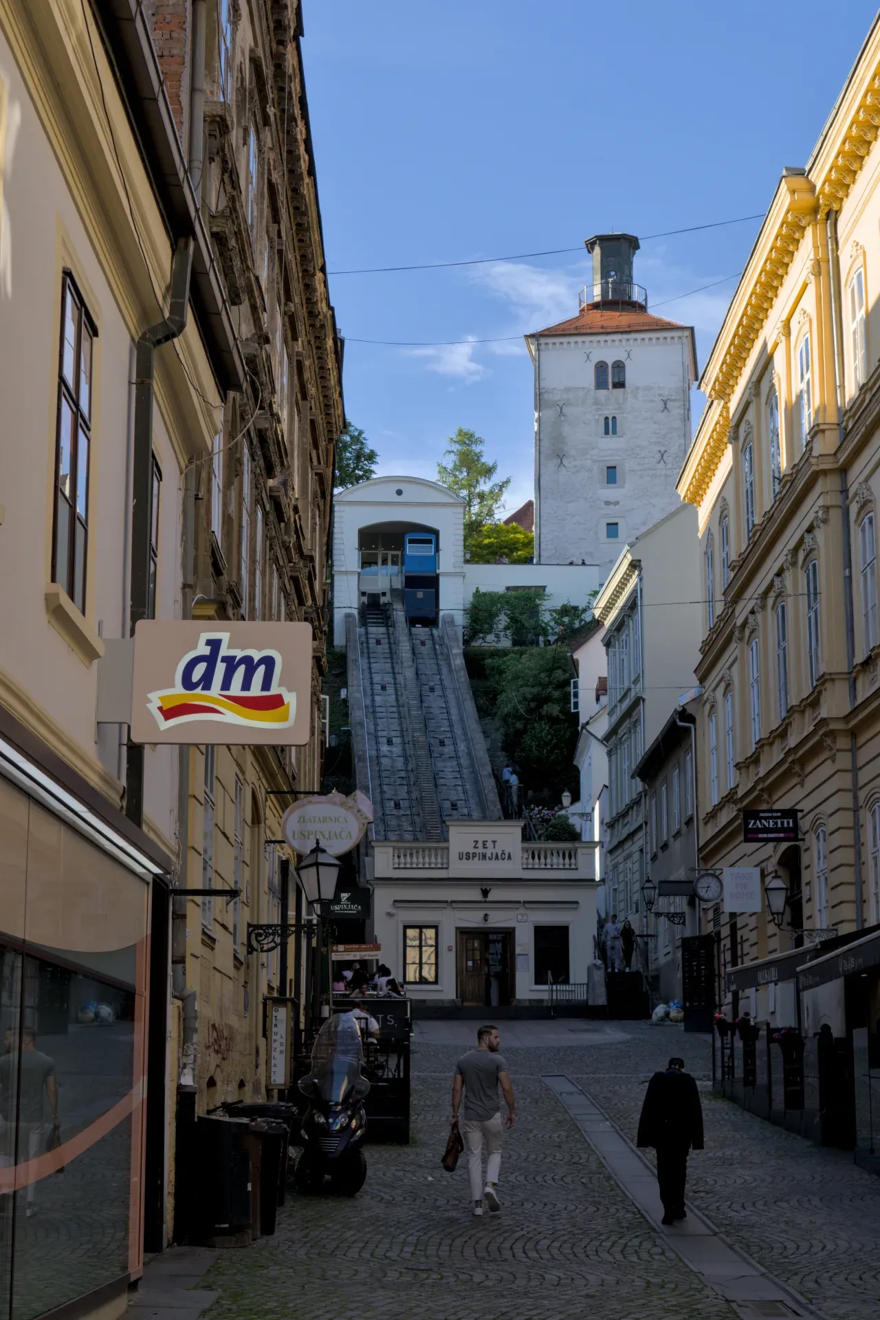 The Zagreb funicular winds between historic buildings, an iconic cityscape.