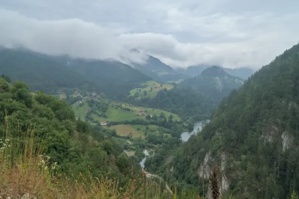 Landscape image with a view of Spajića Lake and surrounding green mountains in Tara National Park, Serbia.