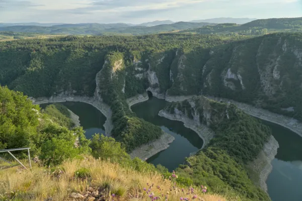 View of Uvac Canyon and Uvac Cave from Molitva viewpoint with a boat on the river.