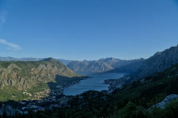 Pre-dawn view of Kotor Bay, Montenegro, overlooking the town and mountains from a serpentine mountain road.