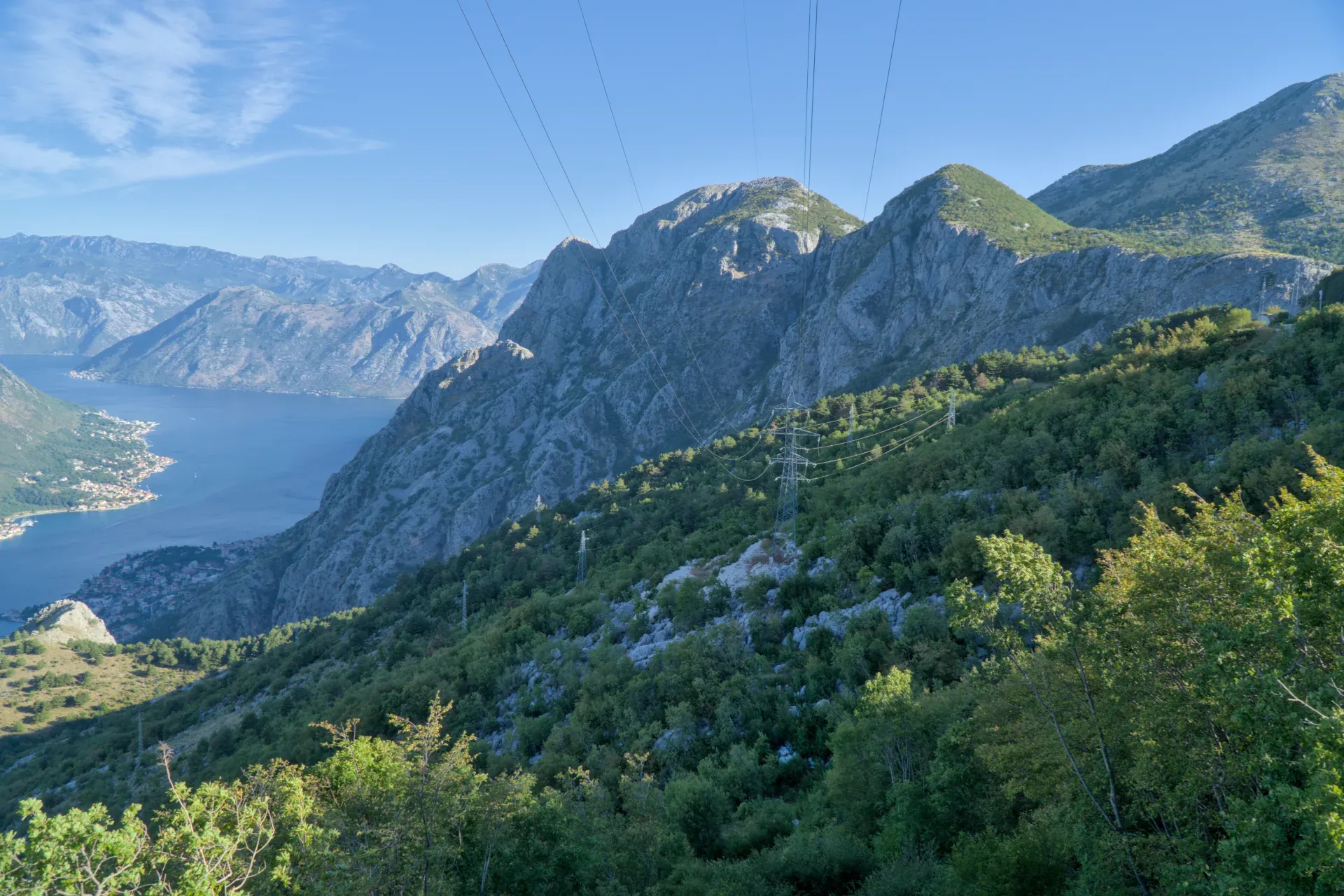 Mountain landscape overlooking Kotor Bay at dawn, bathed in soft light.