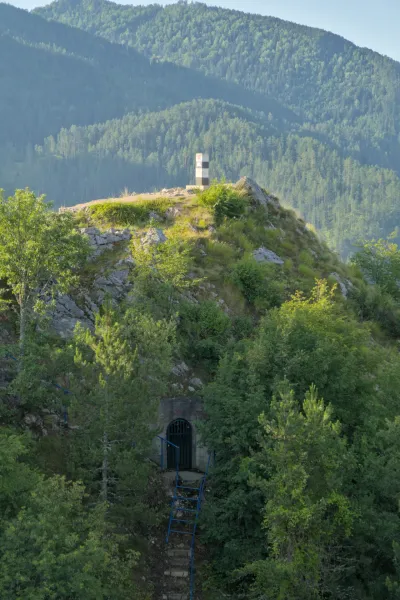 The dam at Zaovine Lake with a mountain entrance and hilltop marker in Tara National Park, Serbia.