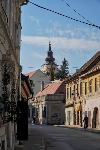 Historic street 'улица Митрополита Стратимировича' in Srem Karlovci with a church spire and old buildings.