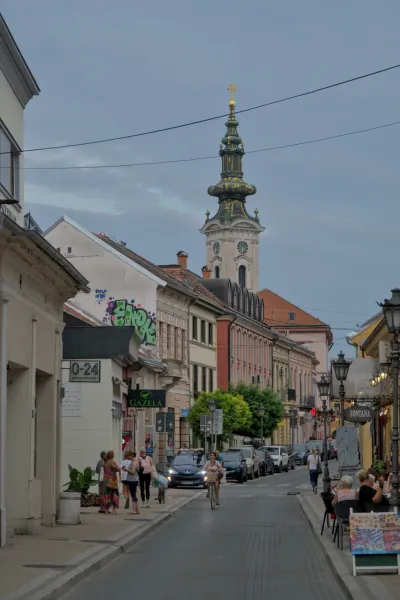 Nikola Pašić Street in Novi Sad, Serbia, featuring a view of St. George Church and vibrant urban architecture.