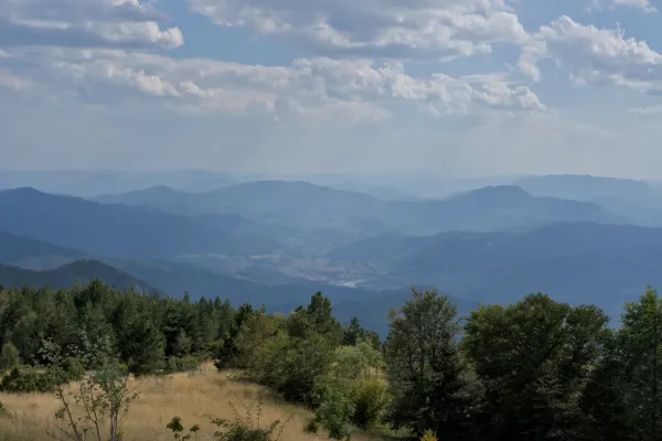 Višegrad from Janjac Peak, Serbia, overlooking vast mountain ranges and valleys.