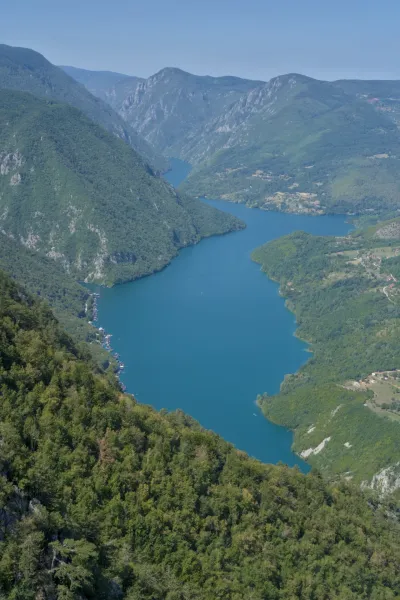 Perucac Lake viewed from Banjska Stena, Tara National Park, Serbia, showcasing blue waters and green mountains.