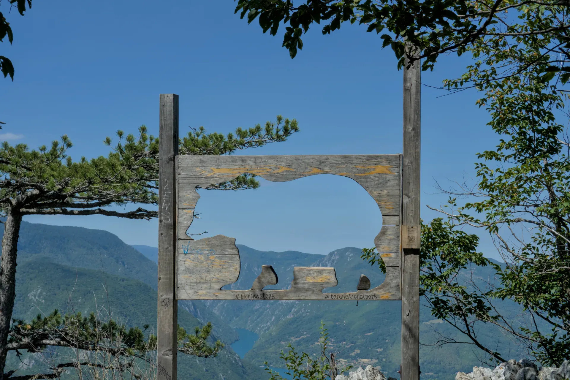 Vista a través de un marco de madera con forma de oso del paisaje montañoso del Parque Nacional Tara, Serbia, desde el mirador Banjska Stena.