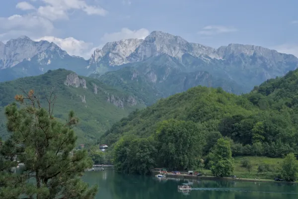 Landscape fine art photograph of a beautiful lake on the way to Mostar, featuring green mountains and serene water.
