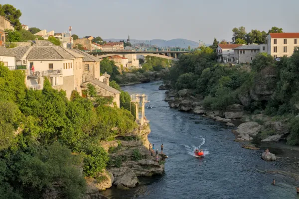 Historic Mostar cityscape with the Neretva River during the "predzakatni chas" (pre-twilight hour).