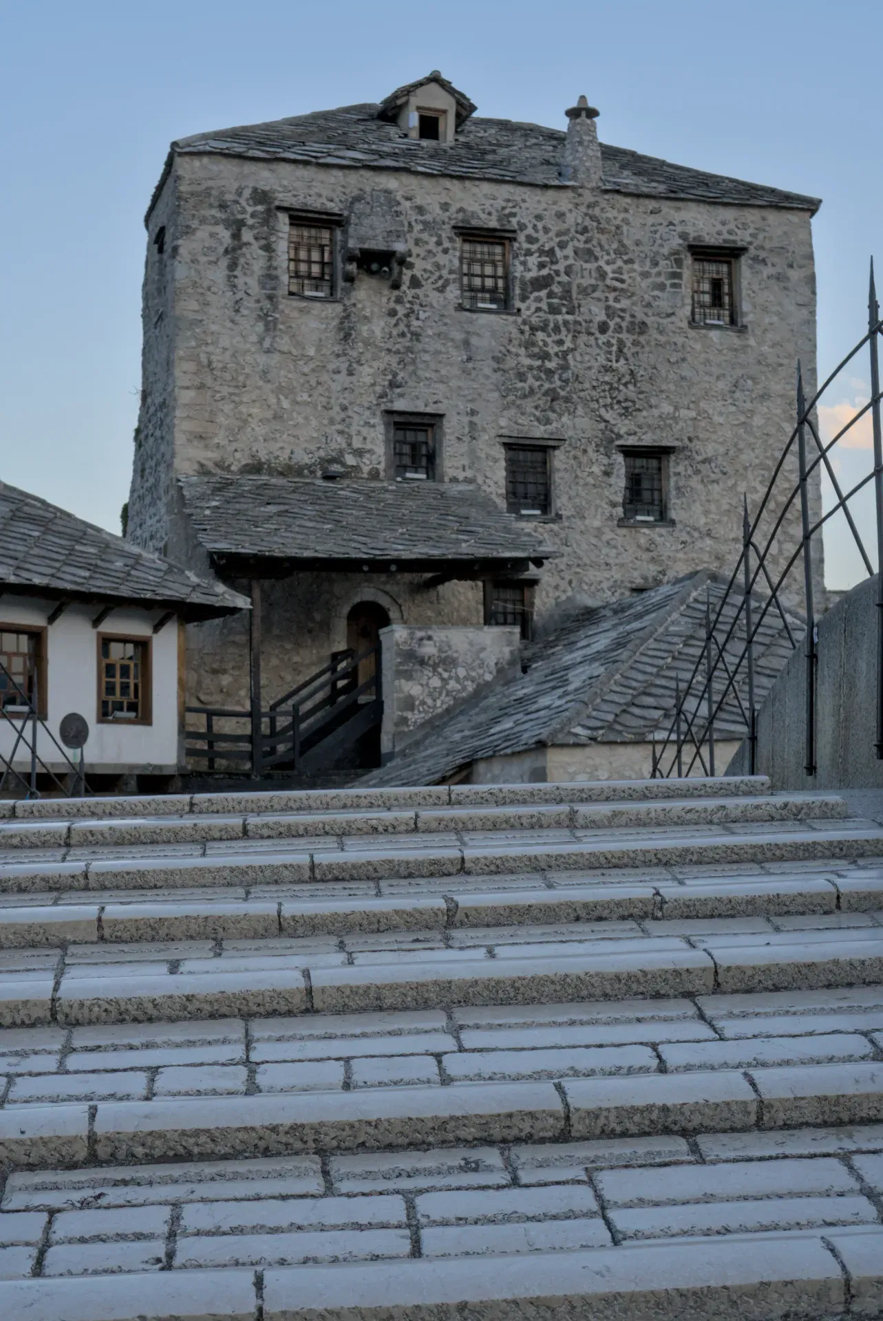 Old Bridge and fortifications in Mostar, Bosnia and Herzegovina, with stone steps in the foreground.