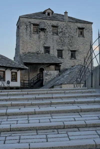 Old Bridge and fortifications in Mostar, Bosnia and Herzegovina, with stone steps in the foreground.