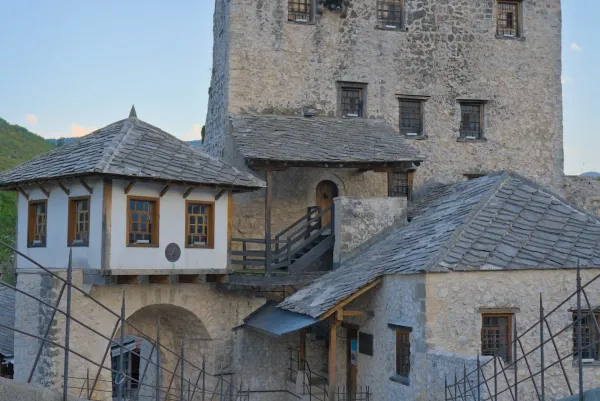 The old stone tower of Mostar's famous bridge in Bosnia and Herzegovina, featuring traditional rooftops.