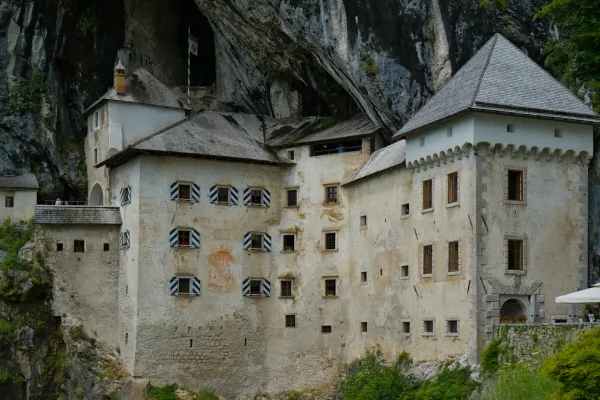 The famous Predjama Castle is built into a cliff face, offering a striking exterior view.