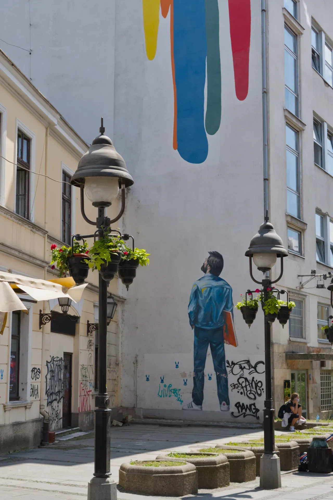 Knez Mihailo Street in Belgrade with a vivid street mural and lights.