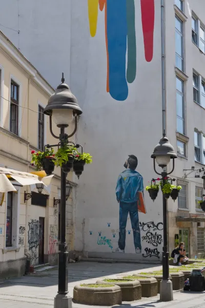 Knez Mihailo Street in Belgrade with a vivid street mural and lights.