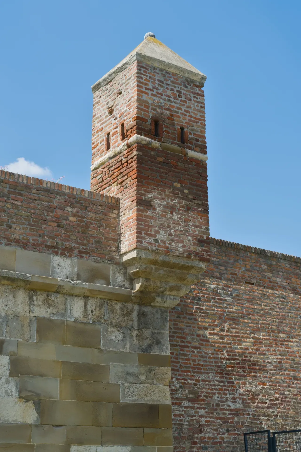Detailed brick tower in Kalemegdan Fortress, Belgrade, Serbia, against a blue sky.