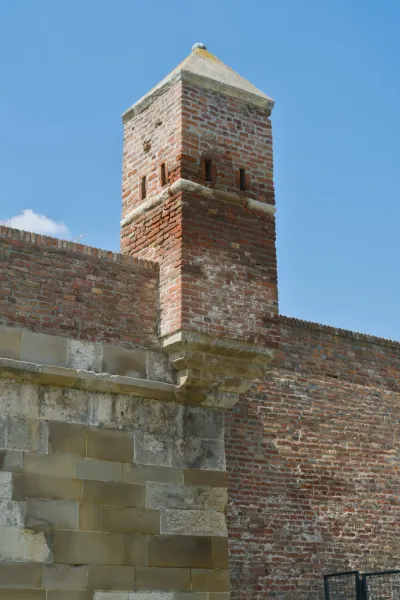 Detailed brick tower in Kalemegdan Fortress, Belgrade, Serbia, against a blue sky.