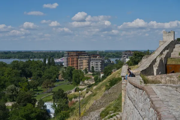 View from the Kalemegdan walls overlooking the confluence of the Sava and Danube rivers, with modern architecture in the background.