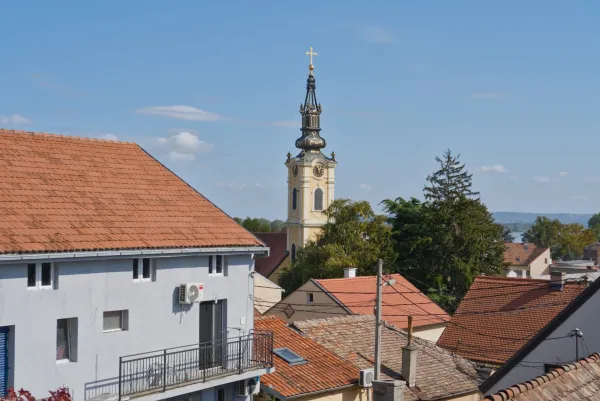 View of Zemun, Belgrade, with a bell tower and terracotta roofs of houses.