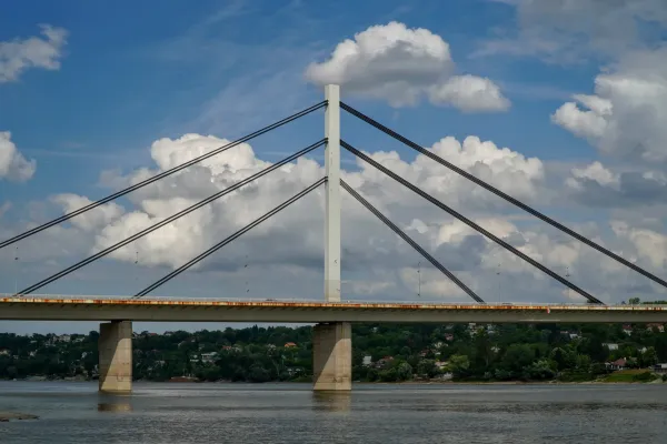 Freedom Bridge in Novi Sad, Serbia, against a dramatic sky with clouds.